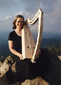 Cynthia with her Ardival Rose harp on a mountain top